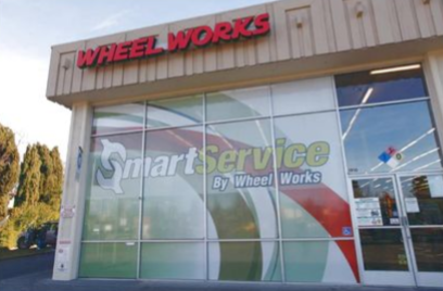 Wheel Works auto service storefront with Smart Service signage and glass windows