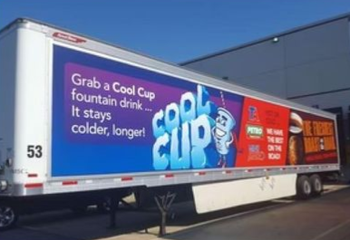 Cool Cup promo on a truck trailer with a blue-and-red beverage ad in a parking lot