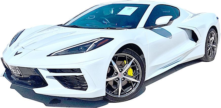 White Chevrolet Corvette C8 sports car angled to the left, featuring dark wheels with bright yellow brake calipers.