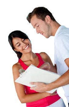 A man and a woman are looking at a clipboard. A man and a woman are looking at a clipboard.
