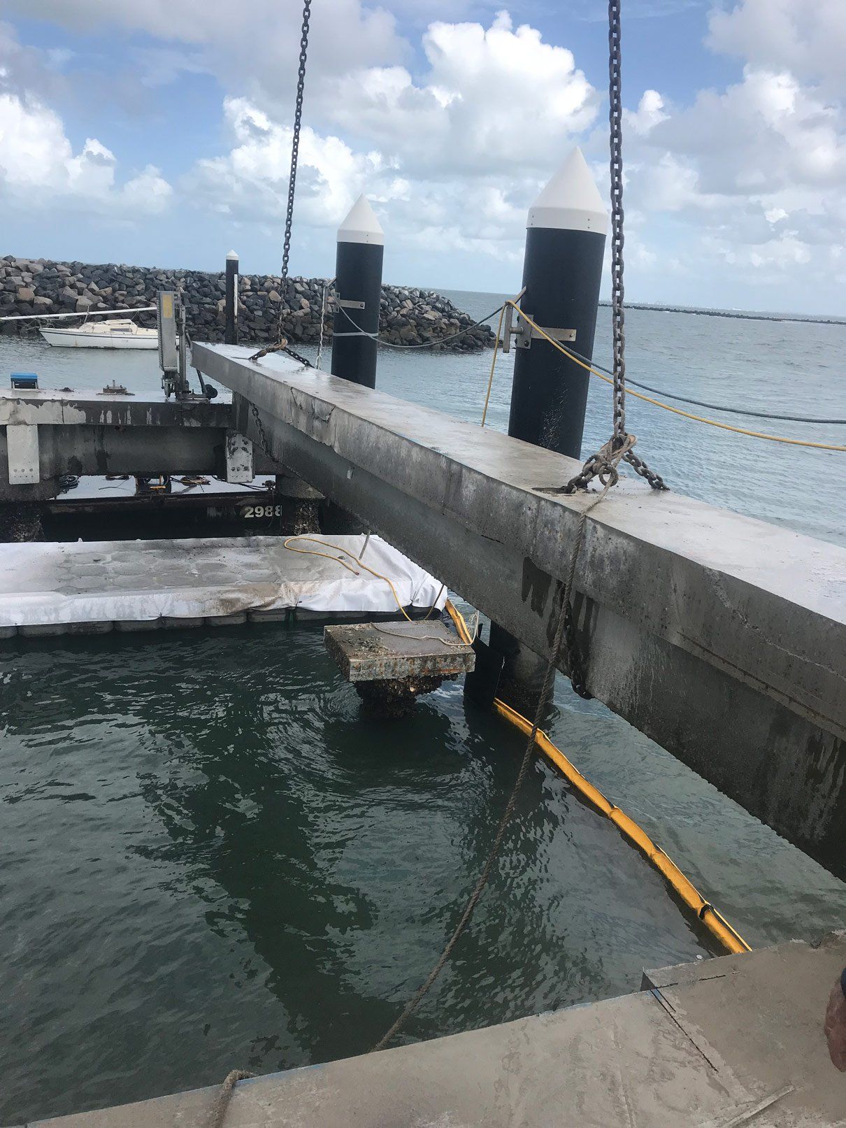 A boat is being lifted into the water by a crane.