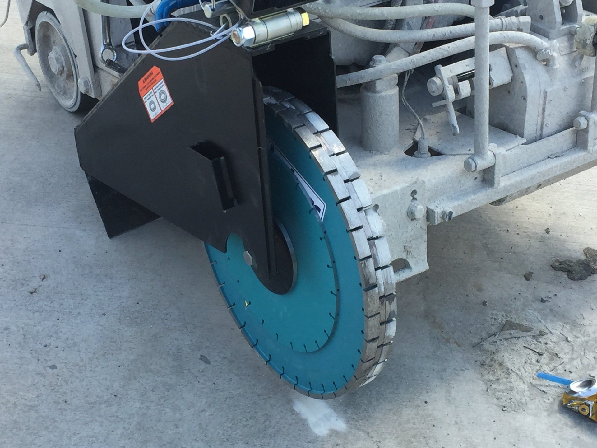 A close up of a machine with a blue wheel