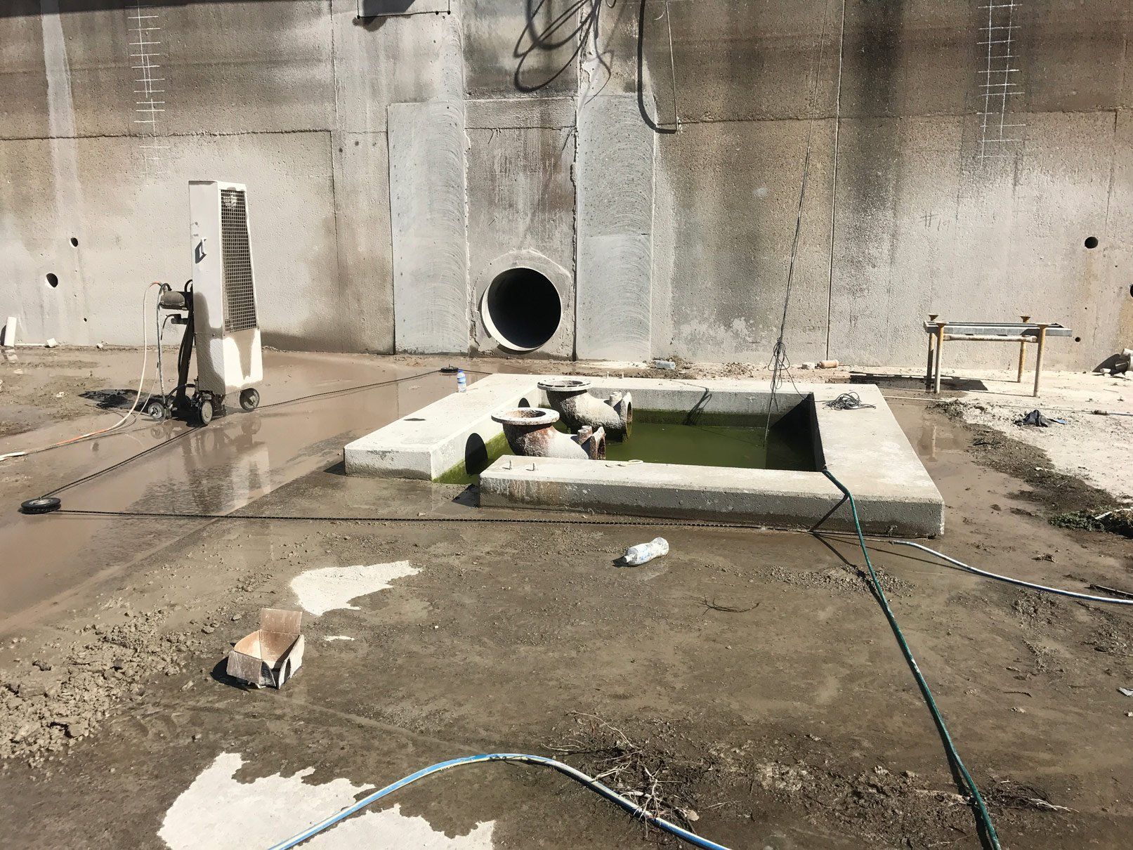 A large concrete wall with a hole in the middle of it