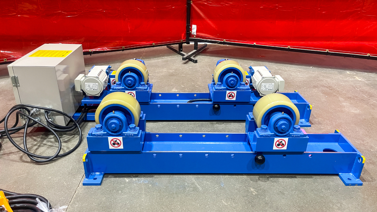 RD-3-INW Tank Turning Roll A machine is sitting on the floor next to a red wall.
