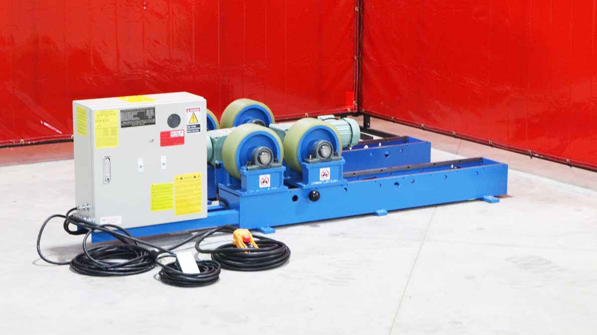 A machine is sitting on the floor in a room with a red wall.