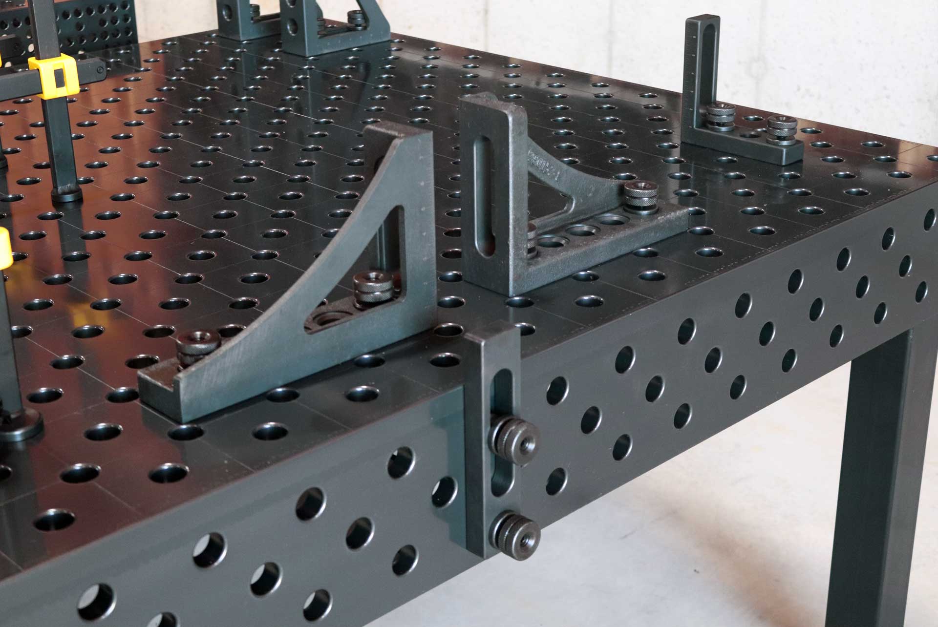 System 28 - Imperial Series Welding Table A welding table with a lot of holes in it