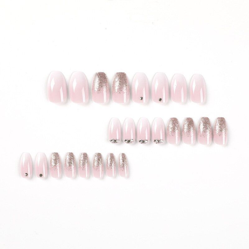 A close up of a woman 's nails with rhinestones on them