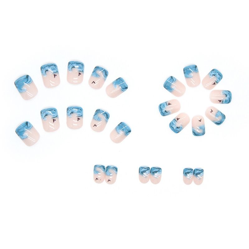 A close up of a woman 's nails with blue waves on them