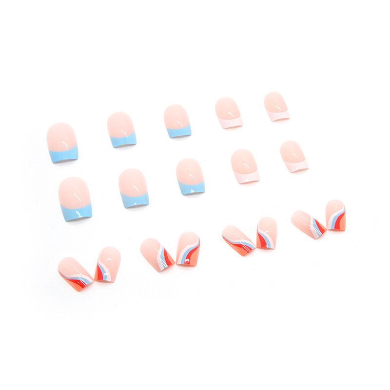 A close up of a woman 's nails holding a white circle