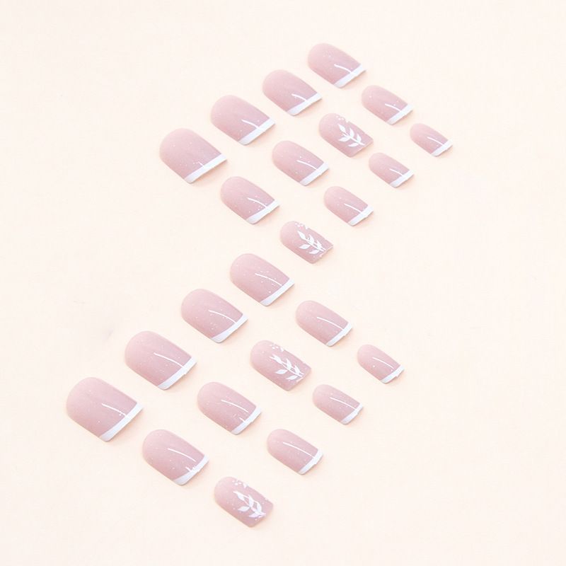 A close up of a woman 's nails with a white french manicure