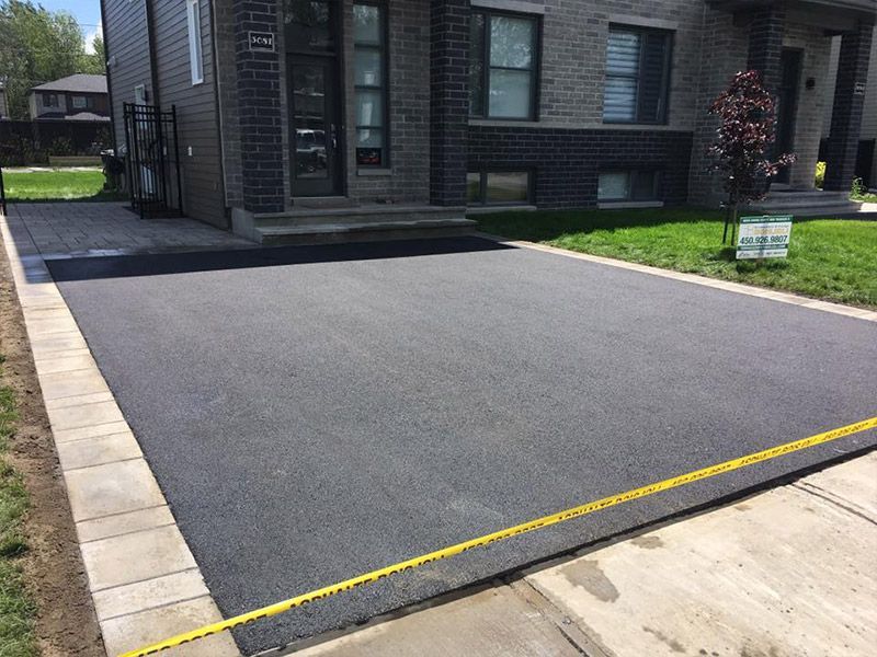 Une allée est en cours de construction devant une maison en briques.