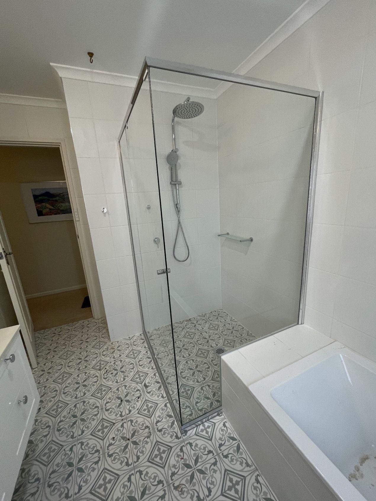 A bathroom with a walk in shower and a bathtub.