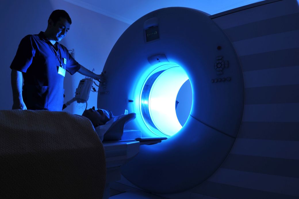 A doctor is holding an x-ray of a person.