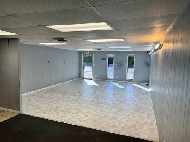 Open showroom with glass storefront entry and display windows in the 1,200 SF space at 1402 Central Parkway SW