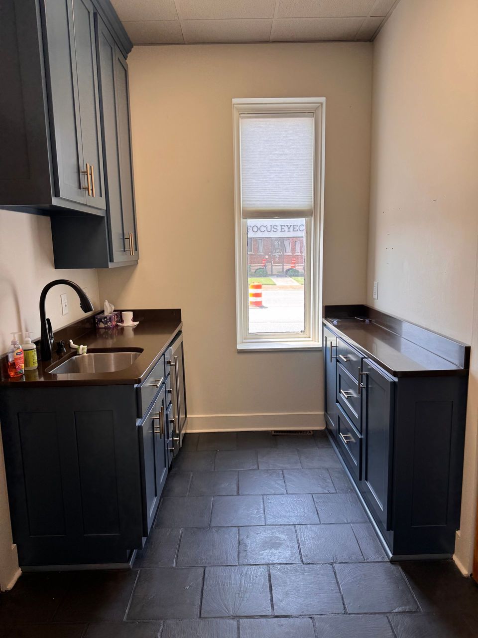 Break room with sink and cabinets in the first floor suite