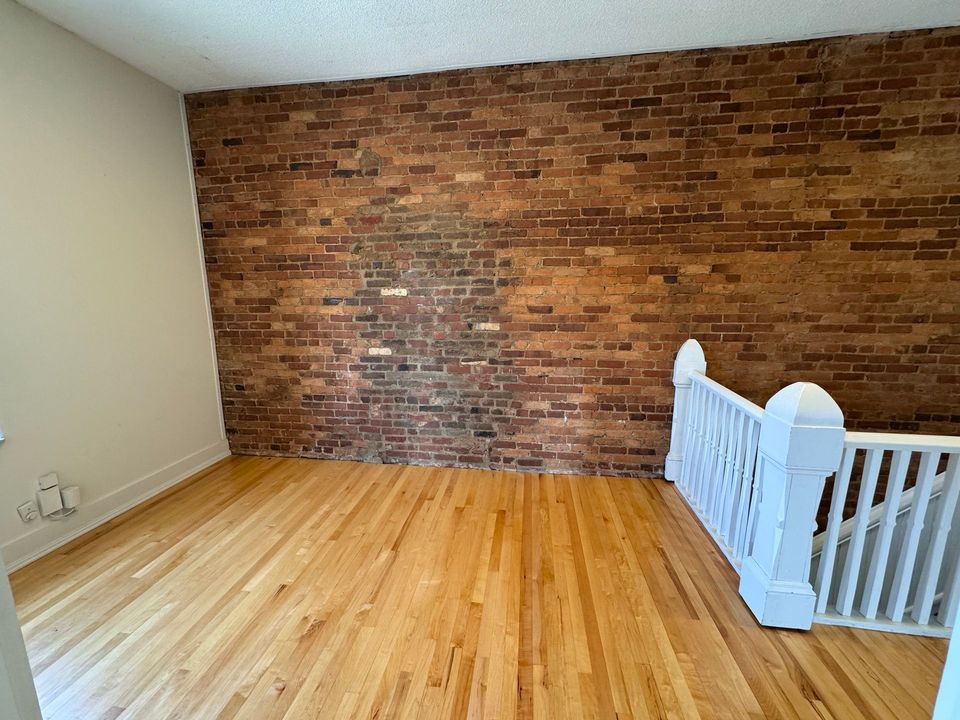 Upper level common area with exposed brick wall