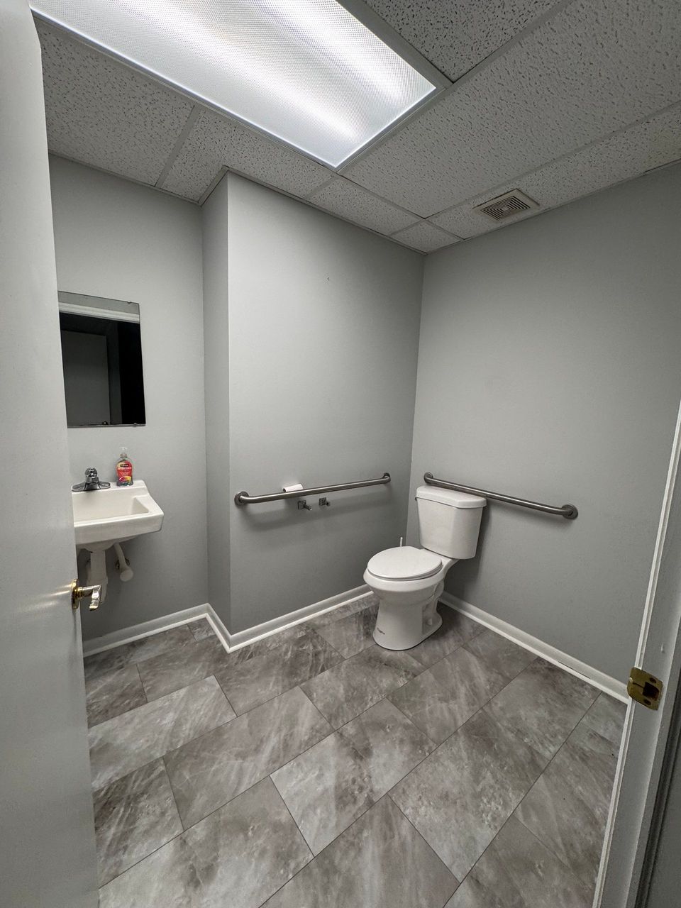 Private restroom with grab bars in the 800 SF office suite