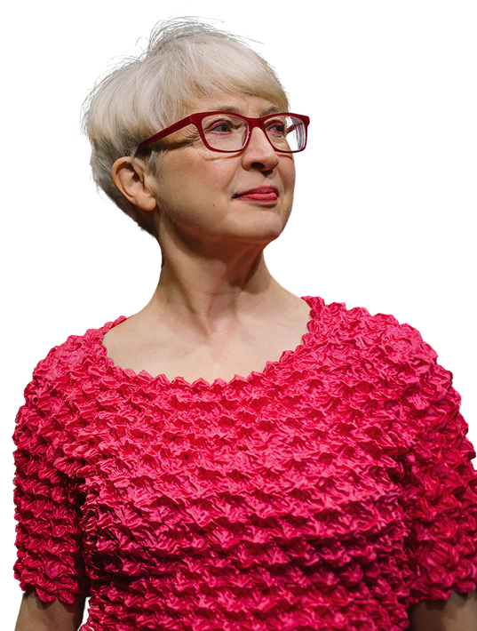 Andrea wears glasses and a pink top.