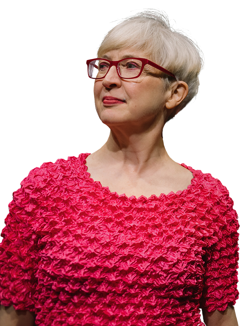 Andrea wears glasses and a pink top.