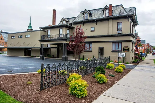 Elegant funeral home with manicured landscaping offering serene and dignified memorial services.