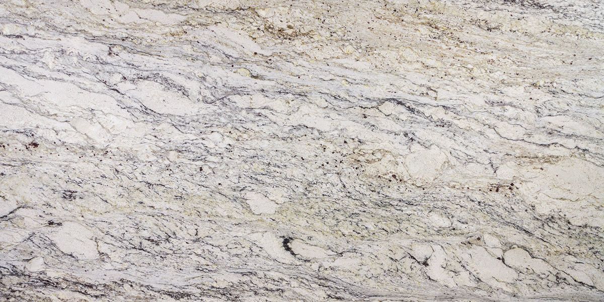 Close-up of a white granite countertop with grey and gold veining.
