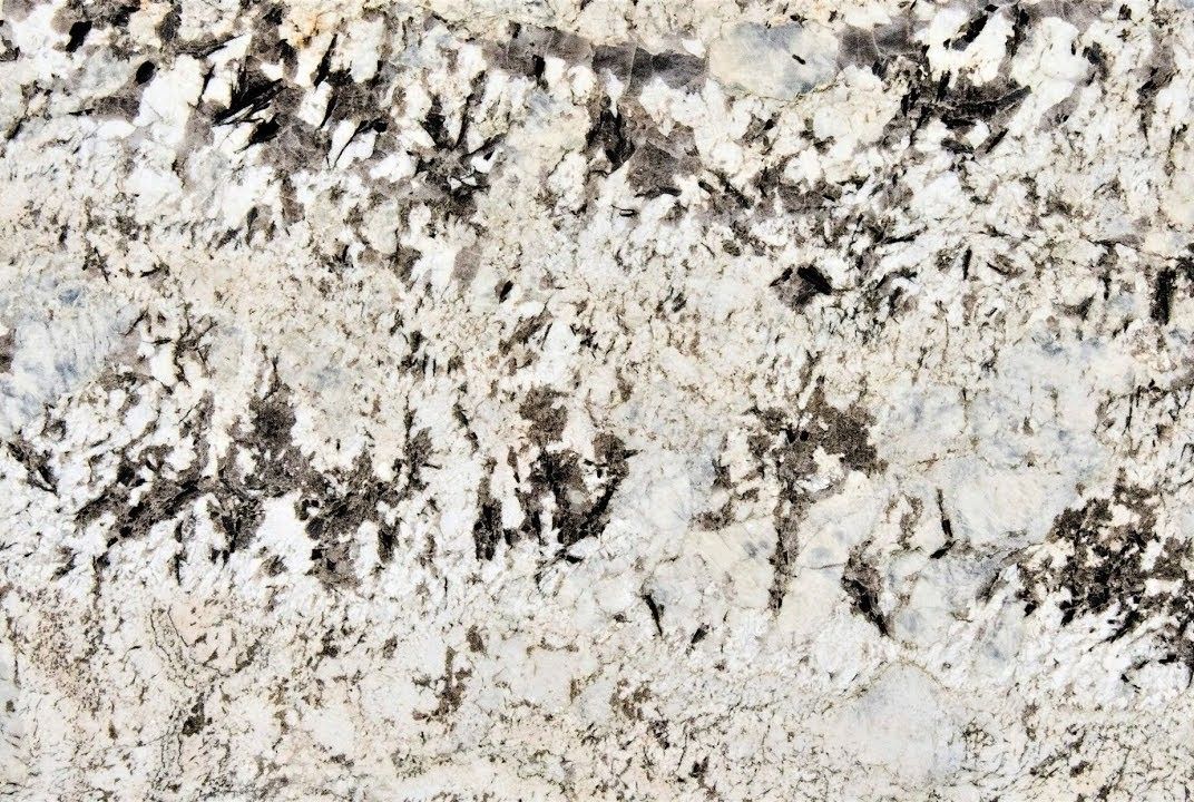 White and beige granite with dark grey and black veining, a natural stone pattern.