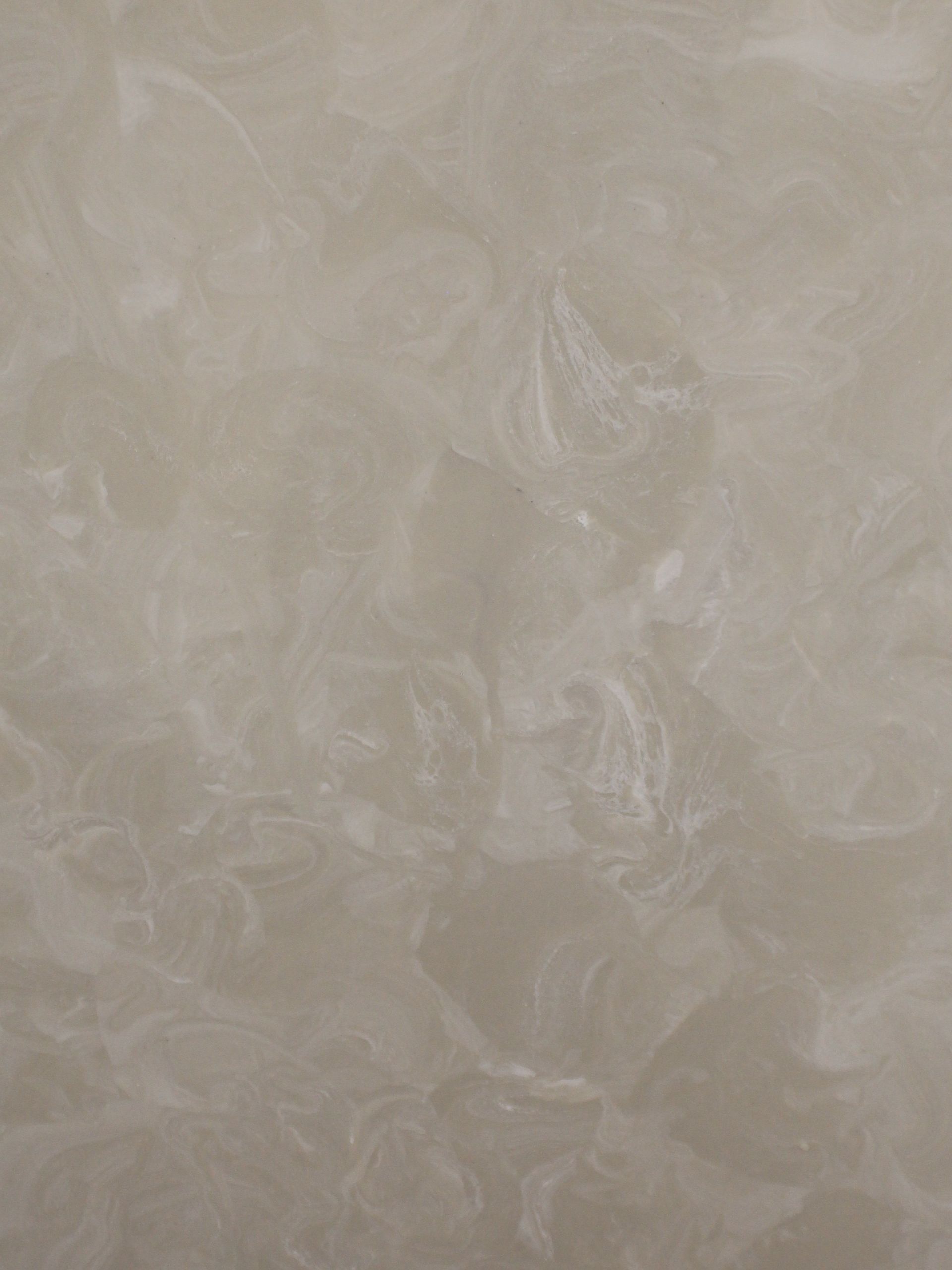 Cream-colored wall texture with swirling, marbled white patterns.