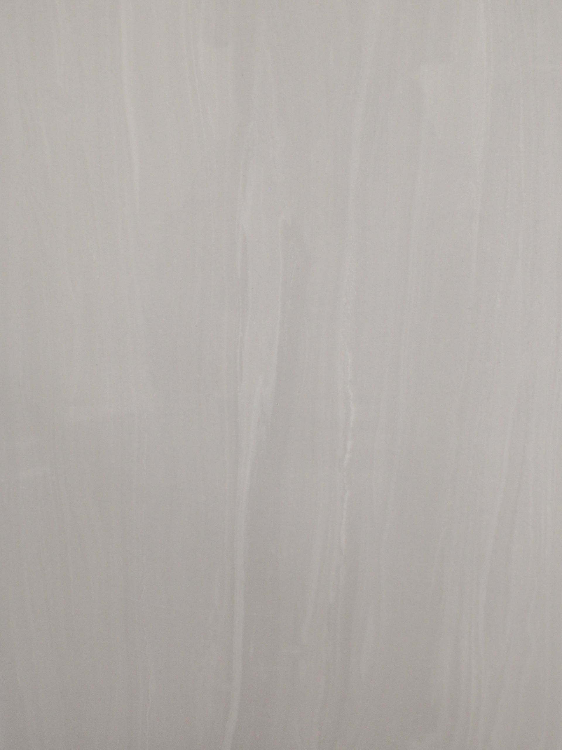 Gray painted surface with vertical brushstrokes.