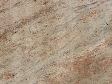 Tan and reddish-brown granite stone surface with flowing patterns and speckles.