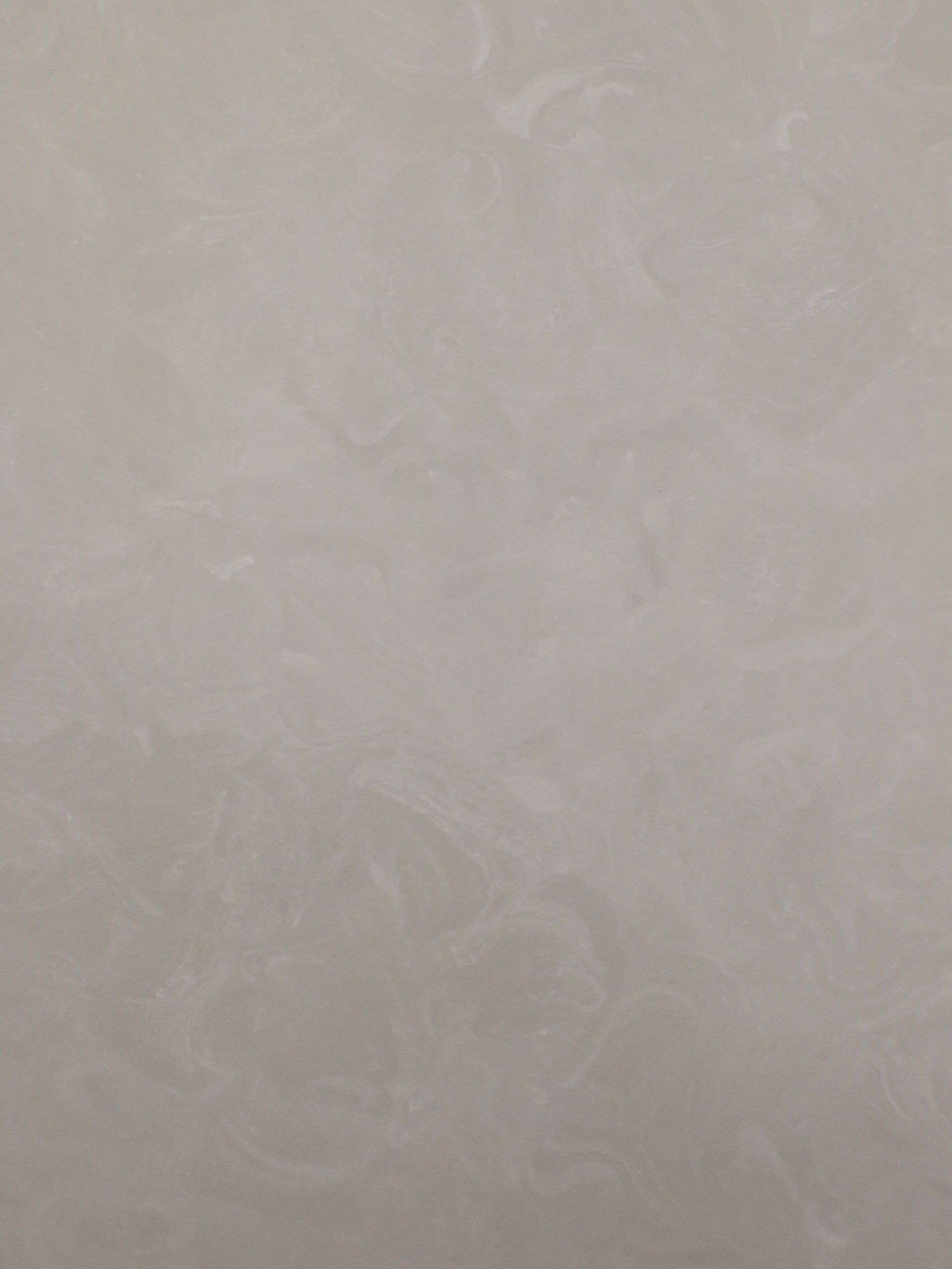 Textured wall surface in shades of beige and gray, with swirling patterns.