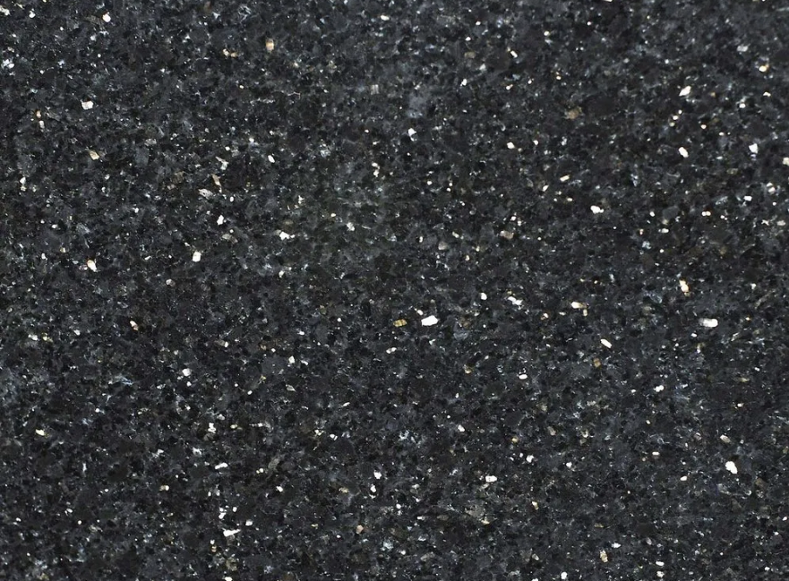 Dark speckled stone surface, resembling a starry night sky.