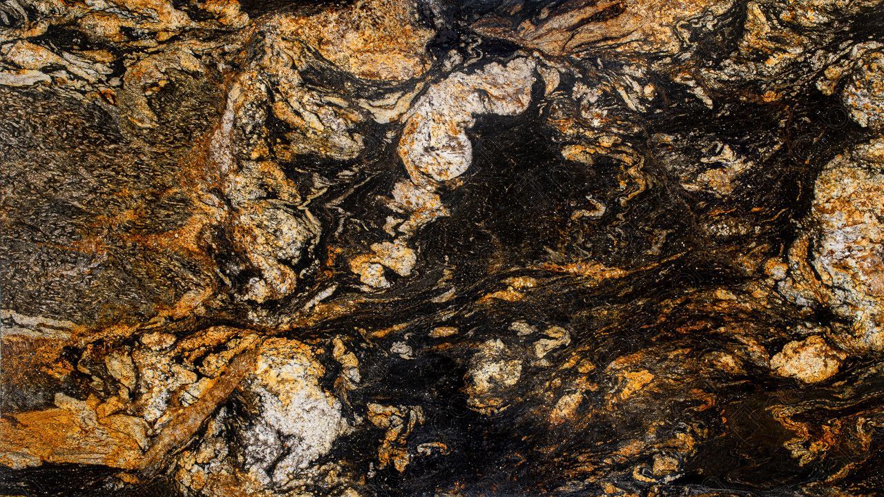 Swirling pattern of black, gold, and white granite.