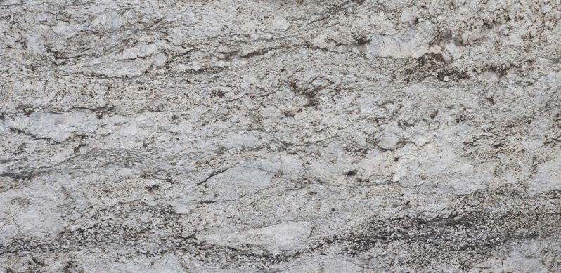 White granite countertop with wavy gray and black veins.