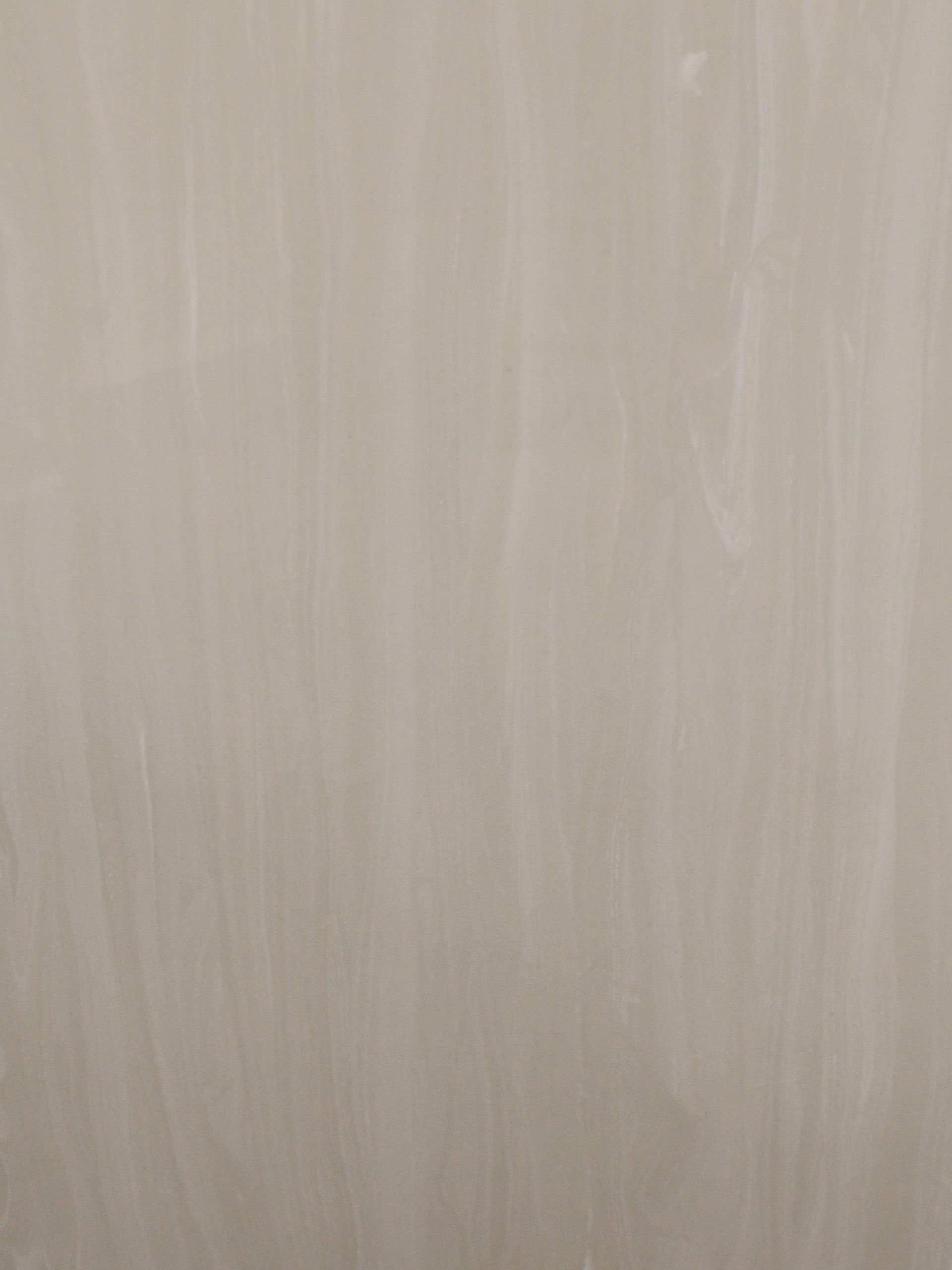 Off-white wall with vertical brush strokes.