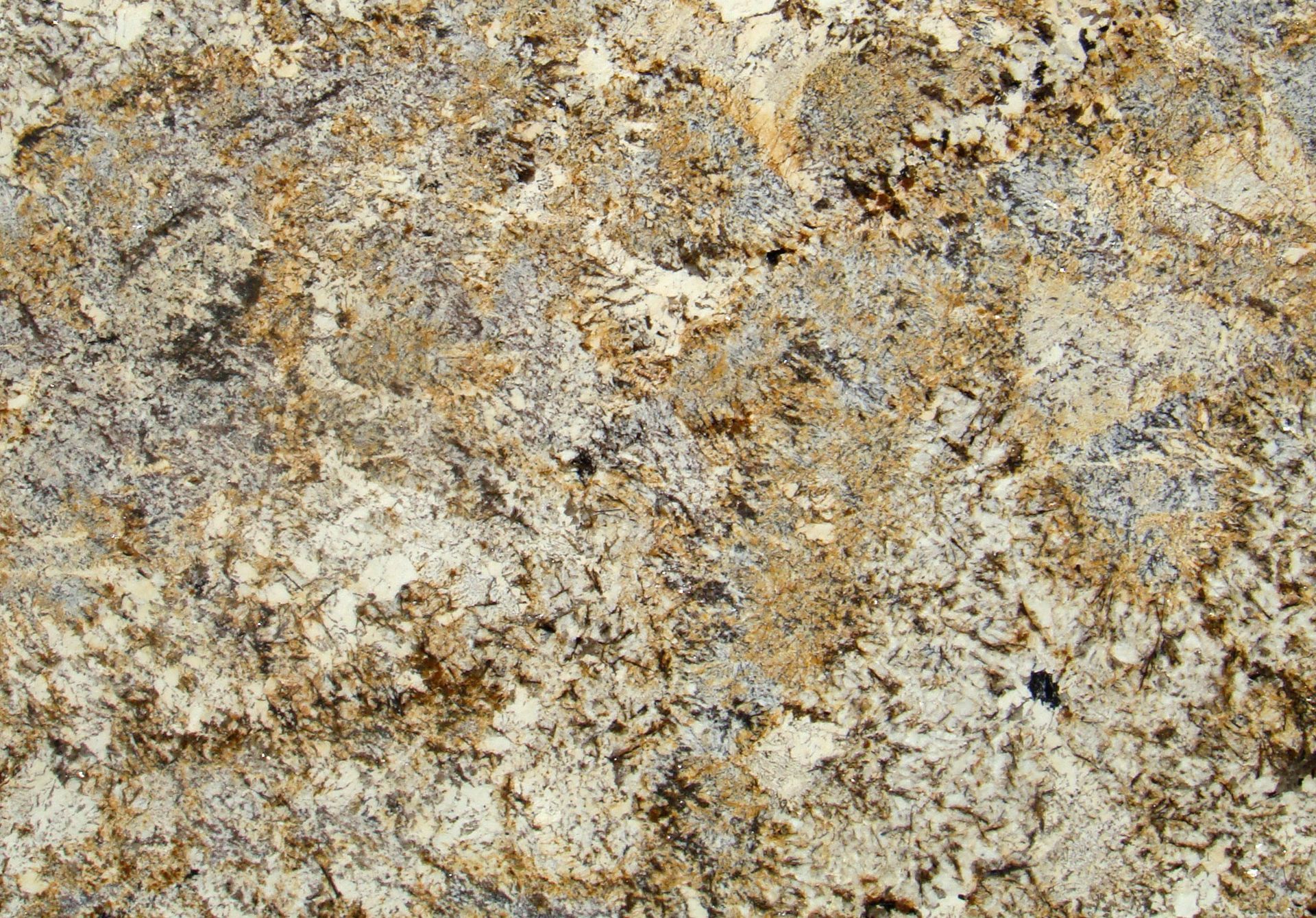 Granite countertop with cream, gold, and gray mottled patterns.