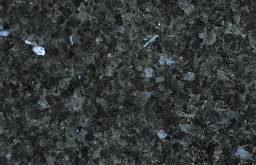 Dark granite countertop with black and gray speckles and blue-gray crystalline flecks.