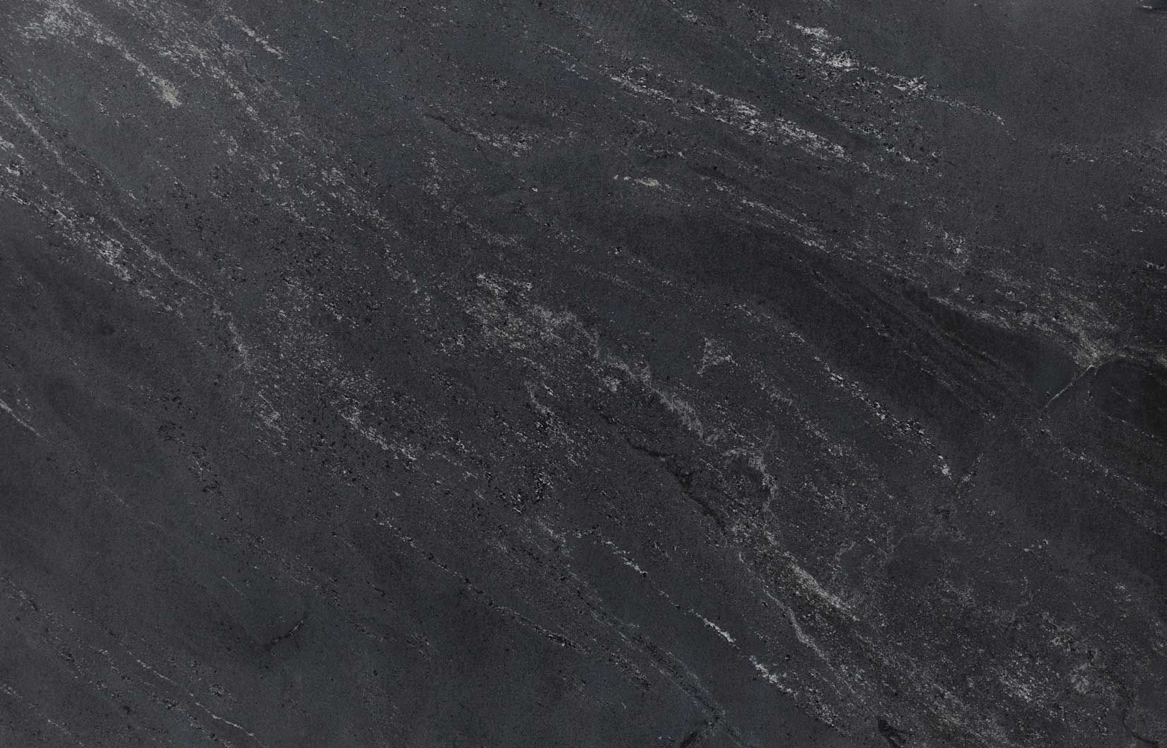 Dark grey speckled surface with subtle white streaks.