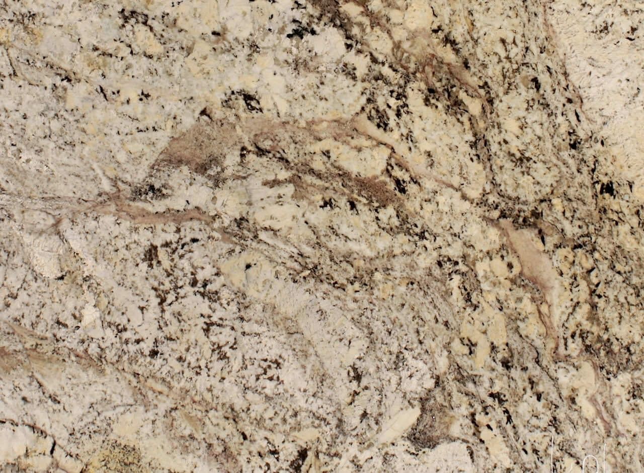 Close-up of granite countertop with tan, brown, and black speckled patterns.