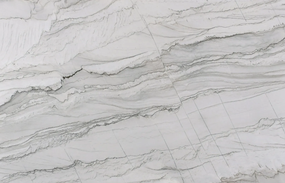 White and gray marble slab with swirling patterns and subtle veining.