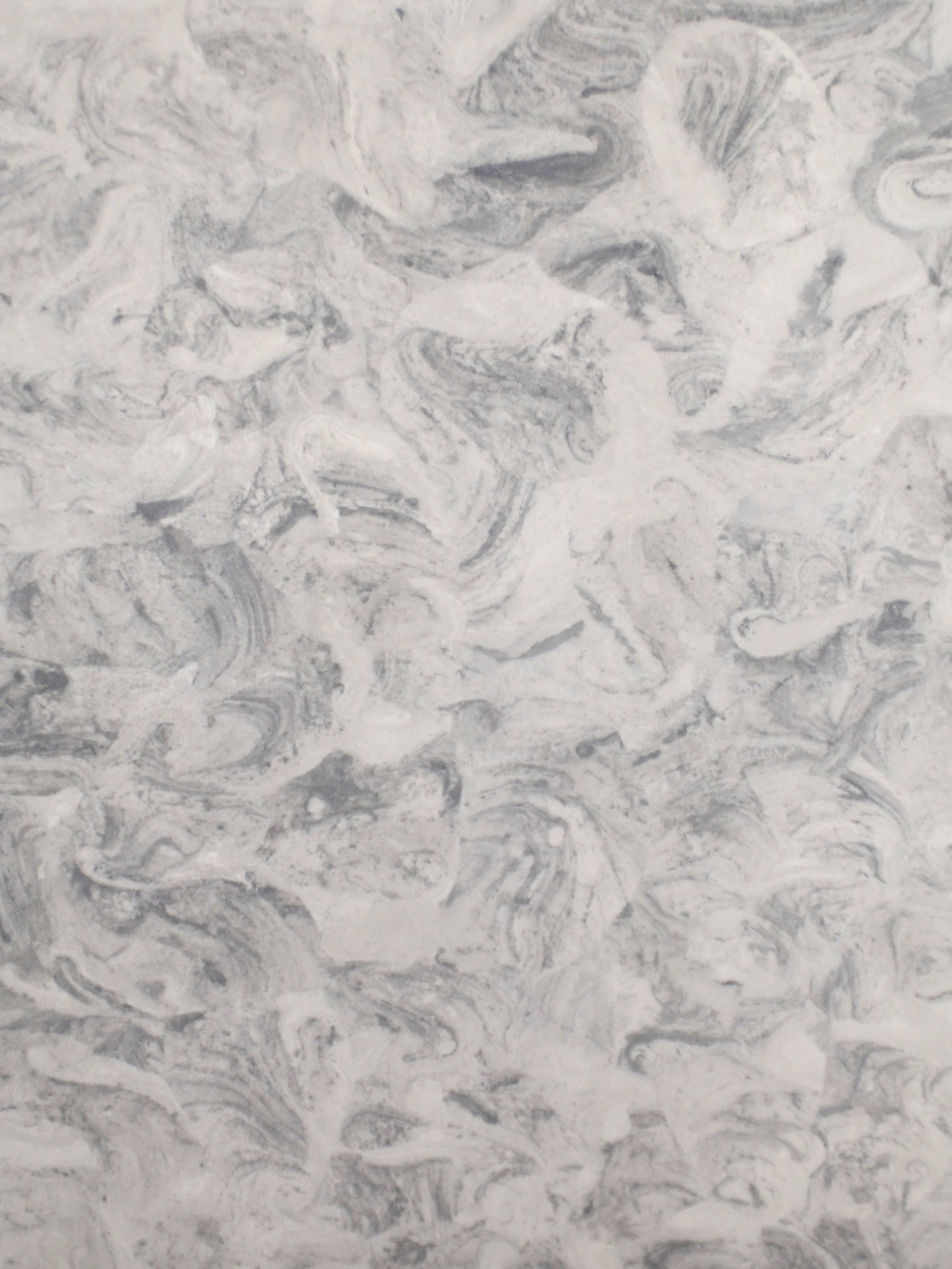 Swirling white and gray marble countertop with varied patterns.