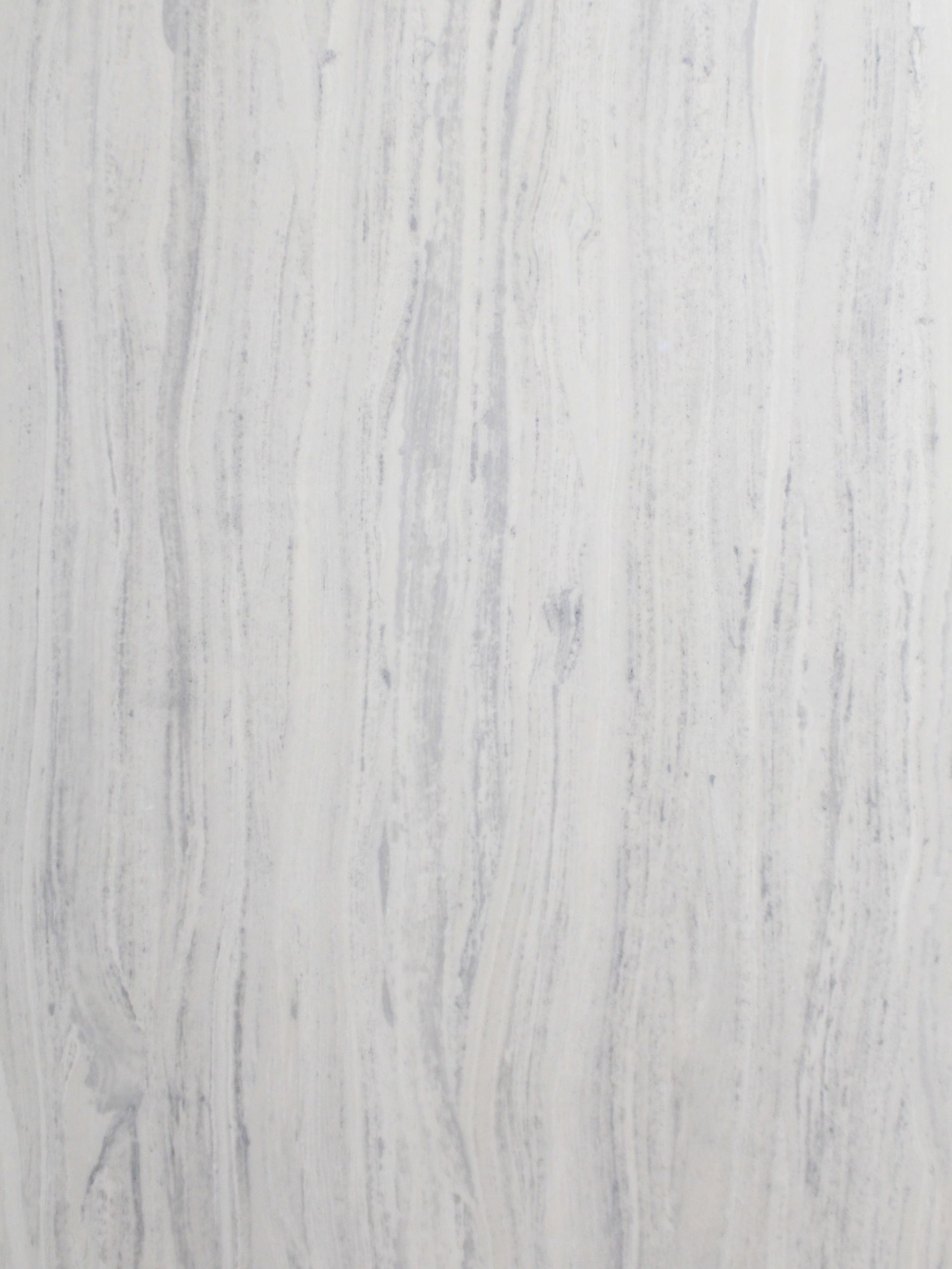 White and grey marbled stone surface, vertical streaks.