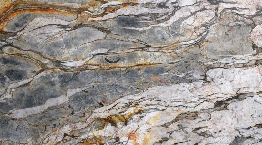 Swirling pattern of gray, white, and brown stone, resembling a topographical map.