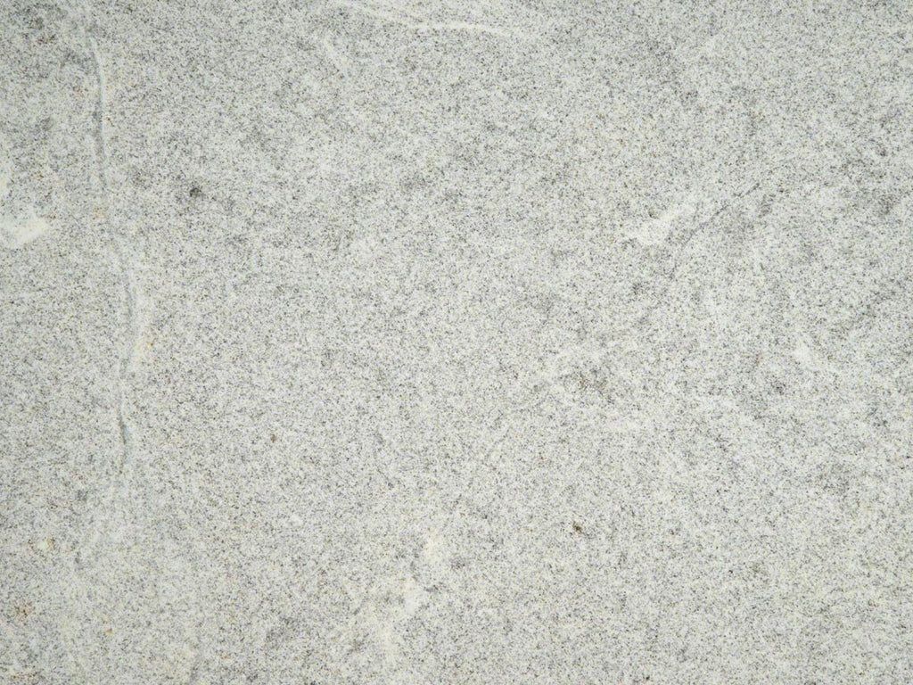 Gray and white granite stone texture with speckled pattern.