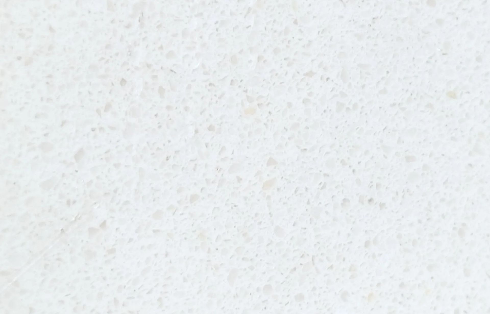 White countertop with small, speckled pattern.