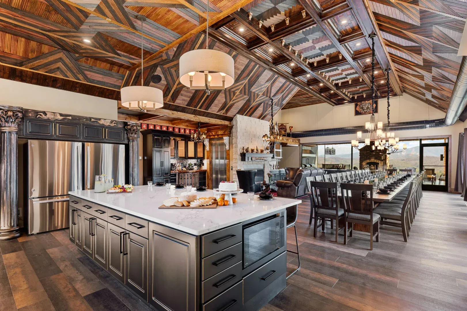 Modern kitchen with large island, stainless steel appliances, and wood ceiling.