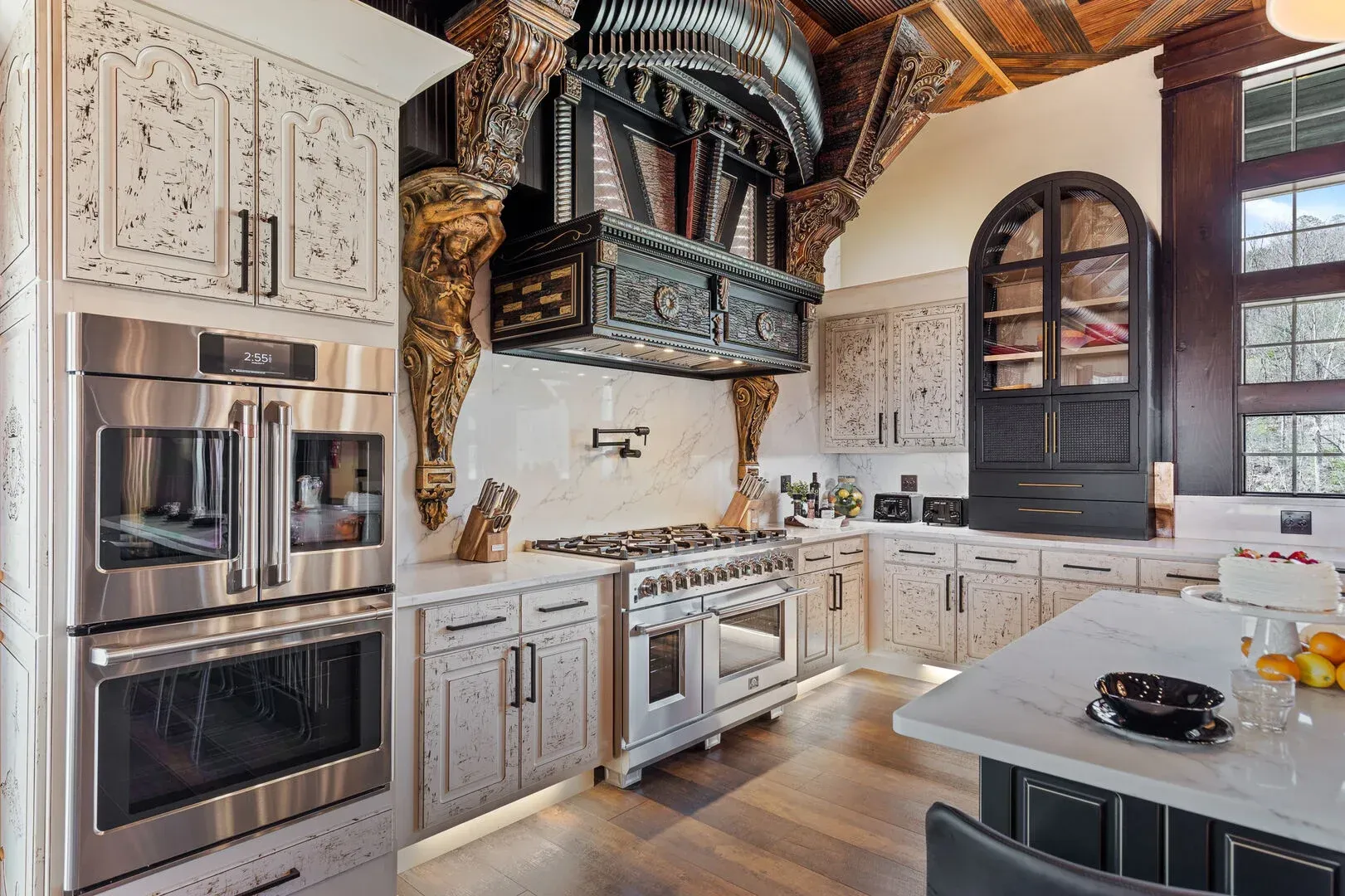 Elegant kitchen with custom cabinetry, stainless steel appliances, and ornate hood over stove.