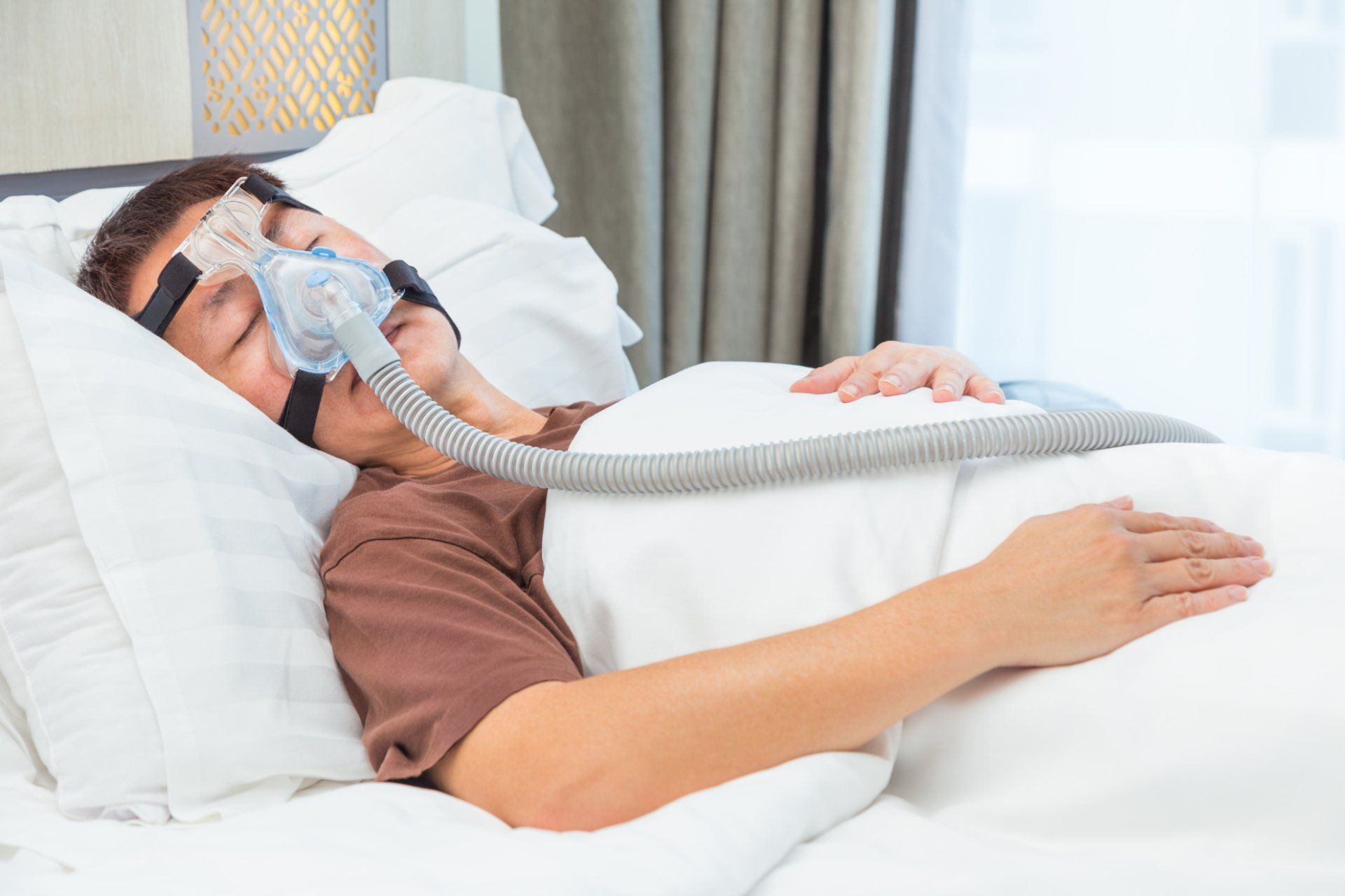 middle-age asian man with sleep apnea mask