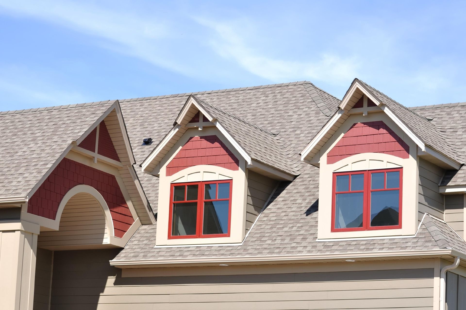 The roof of a house has three windows on it
