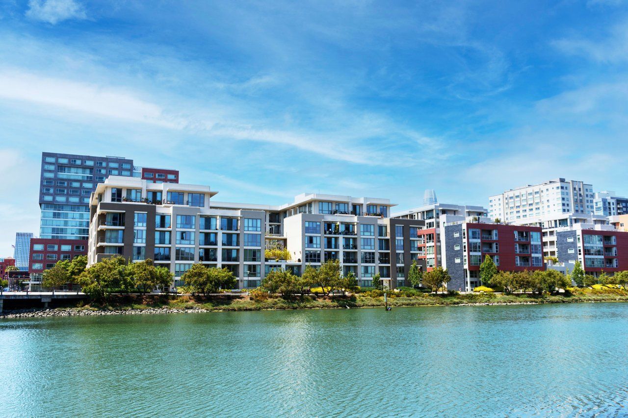 A group of buildings sitting next to a body of water.