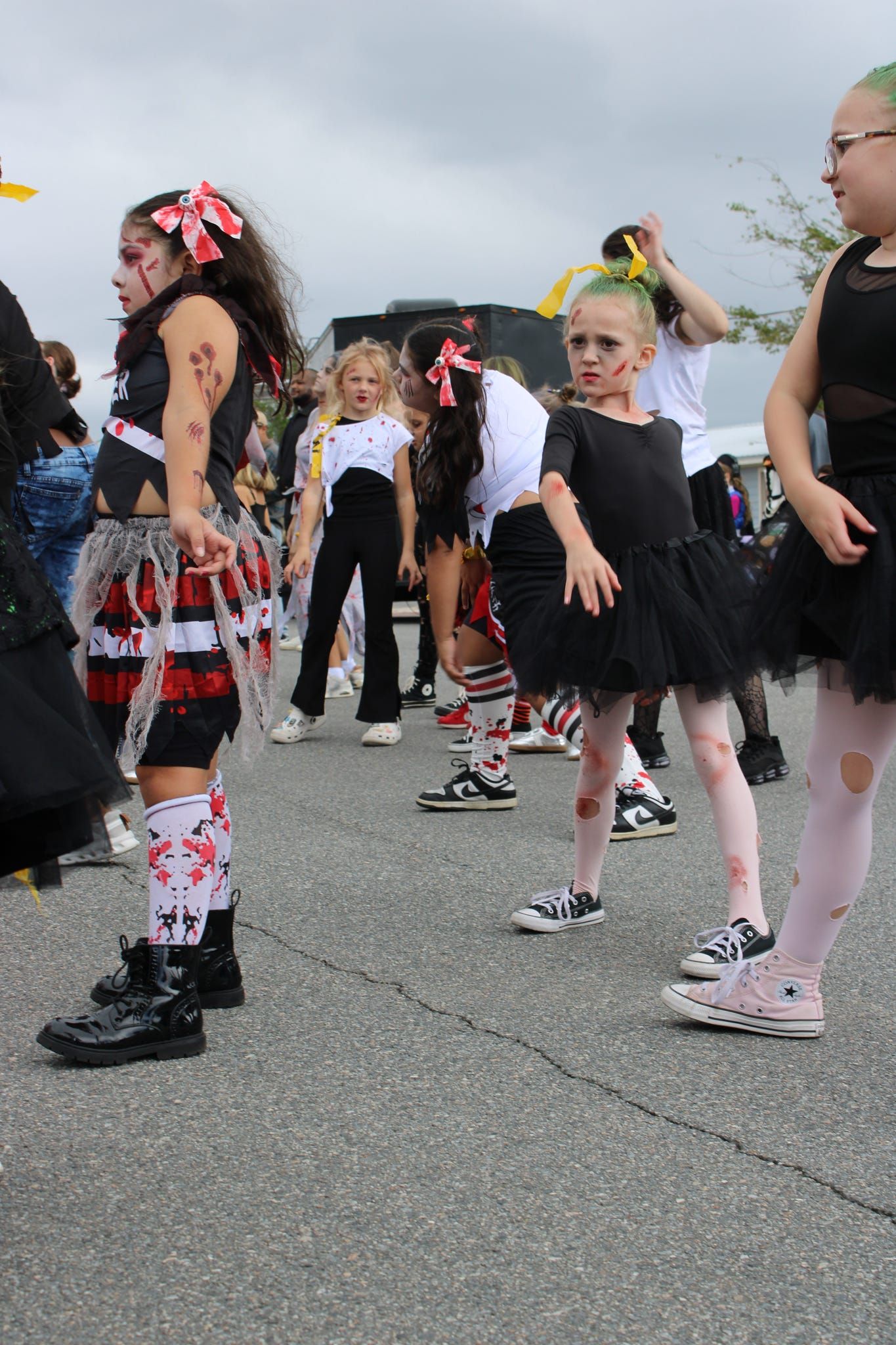 Children in colorful costumes dancing in a street parade